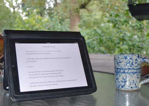 Coffee mug and iPad on the deck