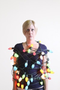 Woman tangled up in holiday lights